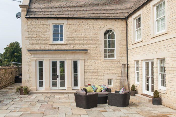 Traditional stone house with architectural details around the windows and doors.