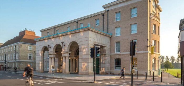 A historic stone building with architectural features such as stone columns and bespoke stone archways.